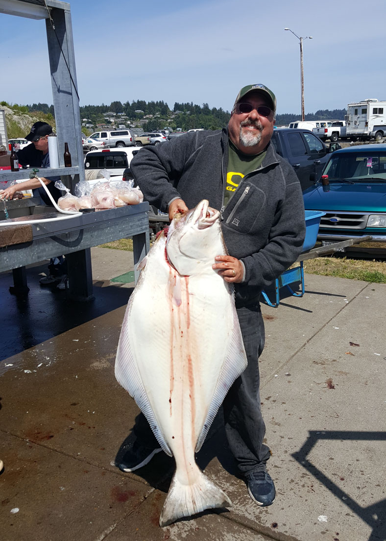 man holding halibut